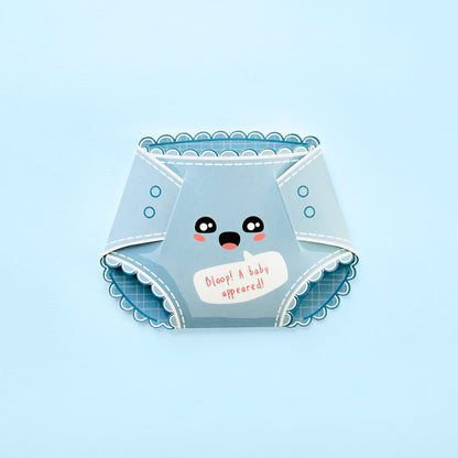 A light blue novelty diaper-shaped card with a cute cartoon face and the text 'Bloop! A baby appeared!' on a light blue background.