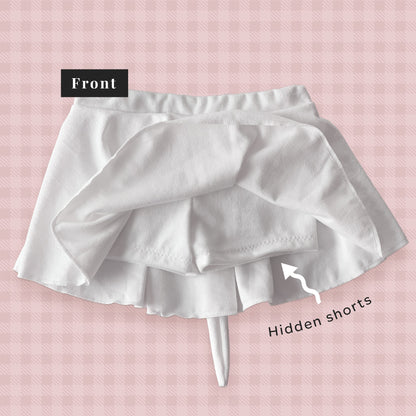 White skirt with hidden shorts on a pink checkered background