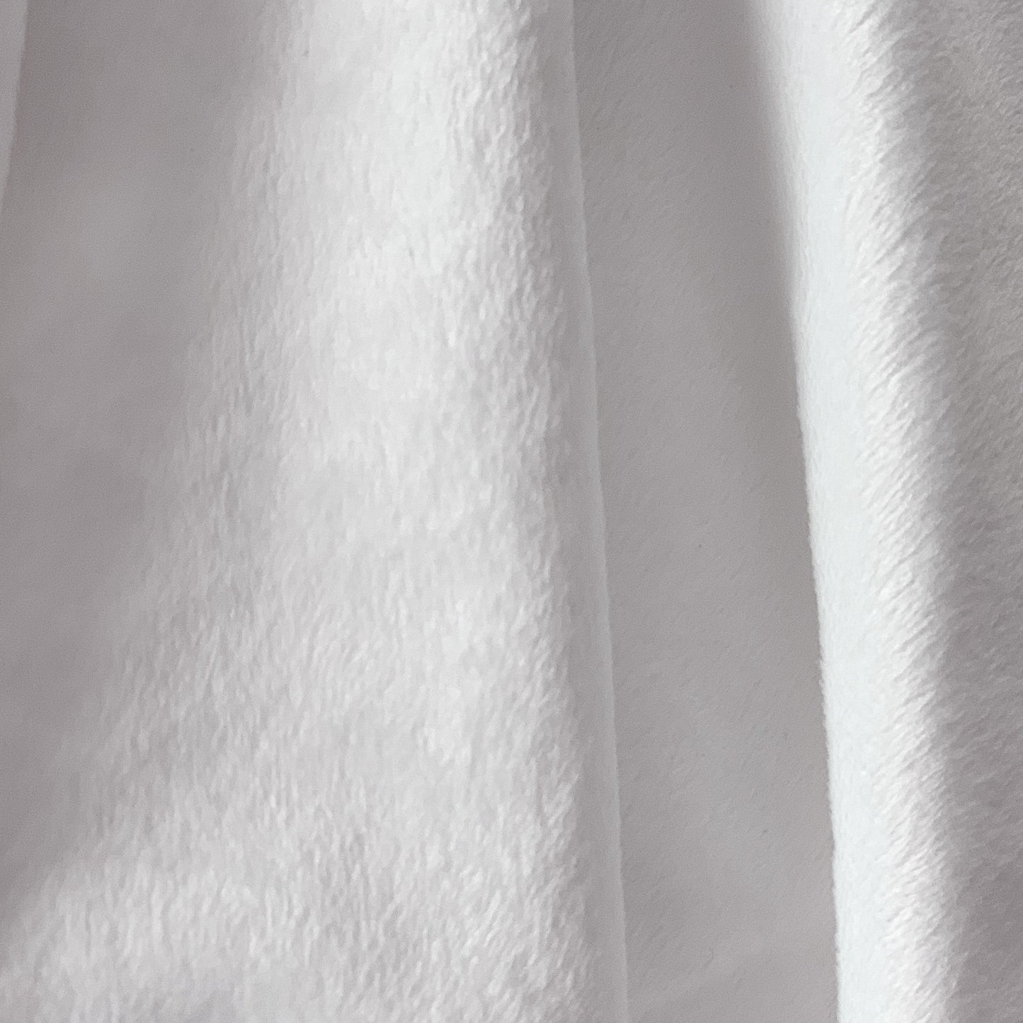 Close-up of white minky fabric with a textured pattern