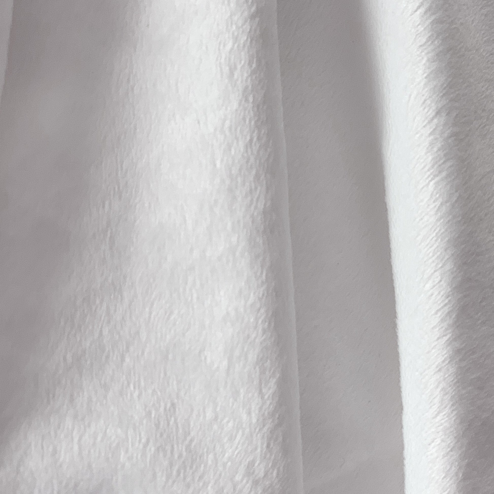 Close-up of white minky fabric with a textured pattern