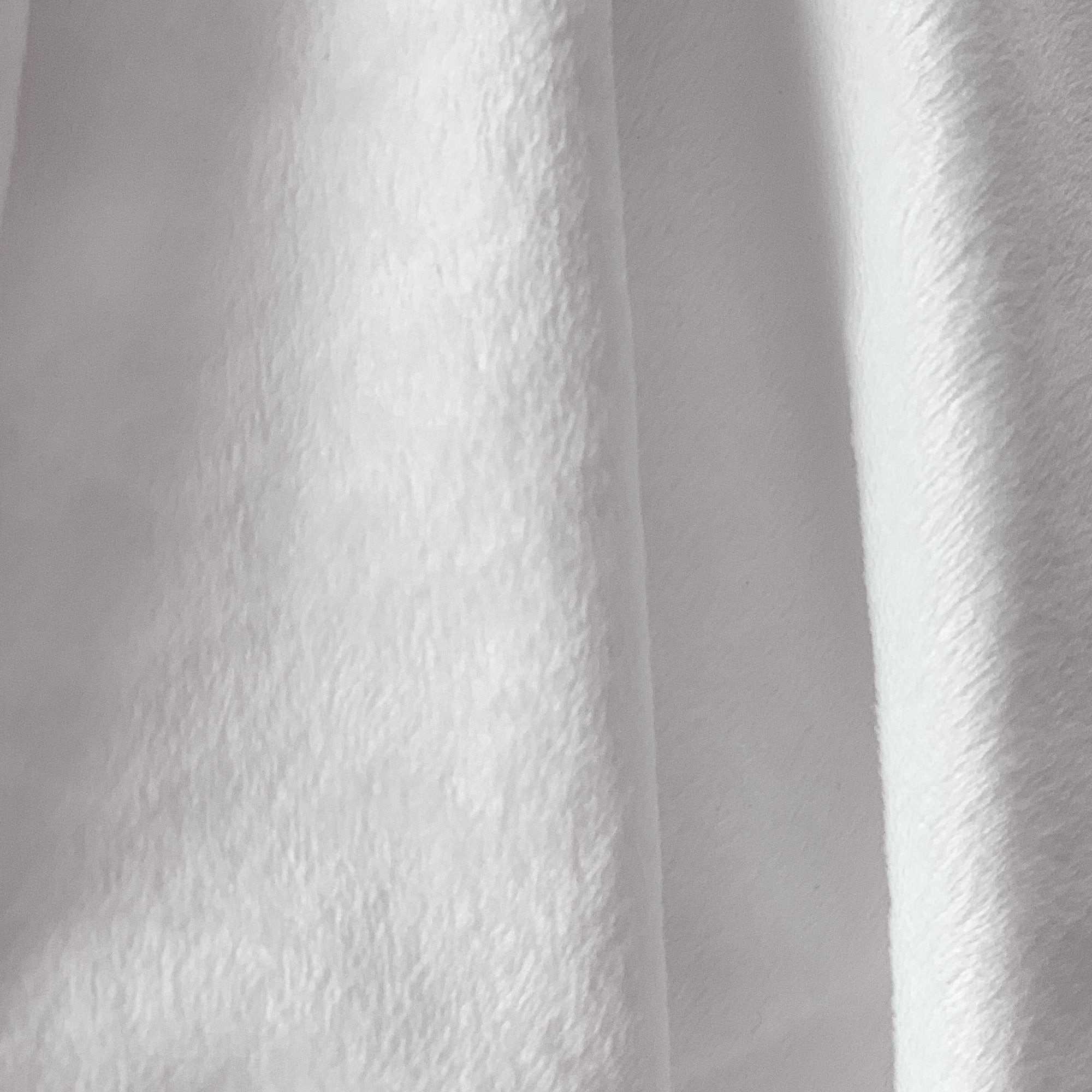 Close-up of white minky fabric with a textured pattern