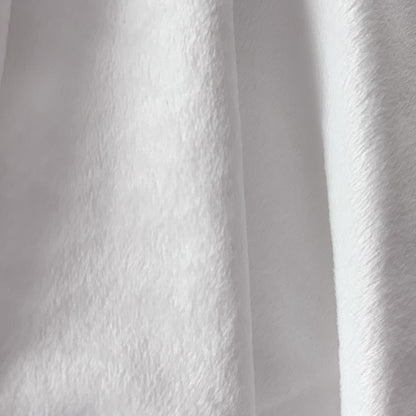 Close-up of white minky fabric with a textured pattern