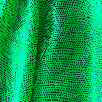 Close-up of green fabric with black dot pattern